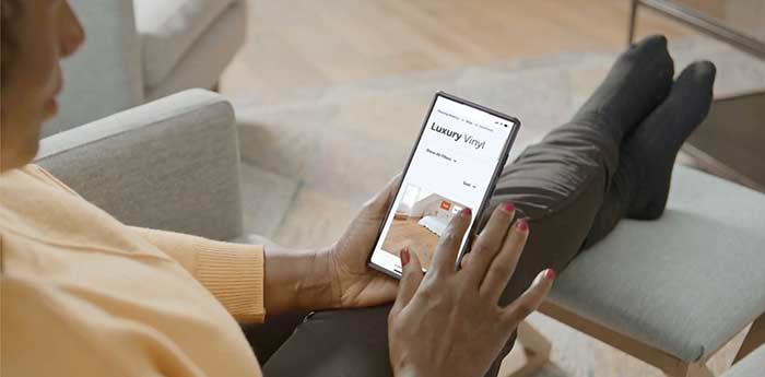 Woman browsing flooring on her cellphone